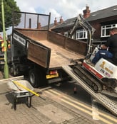 mini digger being loaded onto the back of a van in oldbury