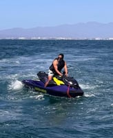 a man riding a jet ski in the ocean