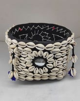 "Bamboo basket wrapped in elegant black fabric with tribal-style shell detailing and floral garland-Export-oriented"