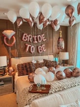 Memorable bridal surprise room with shimmering balloons and luxury “Bride to Be” decor.