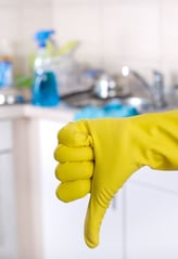 a person wearing yellow gloves and gloves holding a yellow glove