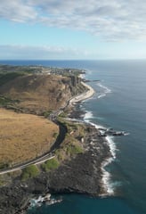 a scenic view of a road and ocean