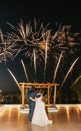 Golden fireworks lighting up a Santorini evening wedding reception.