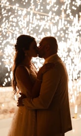 Magical stage fountain fireworks lighting up a Santorini wedding under the stars.