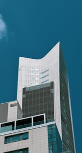 a tall building with a clock towering over a city