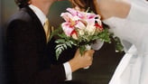 a bride and groom kissing in a wedding photo