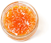 Top-down view of a little, clear, open container of papaya preserves preserves.