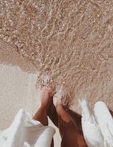 a brides footsteps in sand
