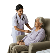 A nurse assists an elderly woman seated in a chair, providing care and support in a healthcare setti