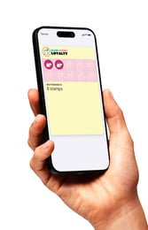 Phone with Claw Store loyalty card on screen