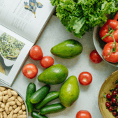 Photo of an open cookbook next to colorful ingredients