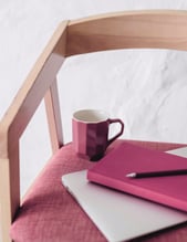 a cup and a notebook on a chair for personal work on reconnecting with yourself