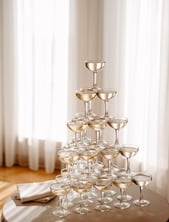 Luxurious champagne tower at wedding reception, crystal glasses in classic pyramid design