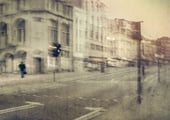 Abstract fine art photograph by Martin Osner showing a blurred urban street scene with historic buildings and a lone figure