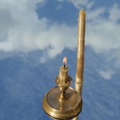 a candle with a candle lite up in the sky