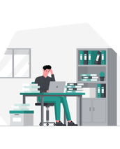 a man sitting at a desk with a laptop and a laptop