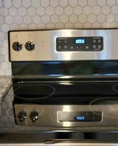 a stove top oven with a clock on the stove