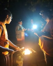 Youth cooking over an open fire