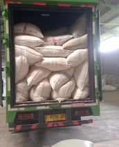 a truck with a large amount of bags of duck feather in the back of it