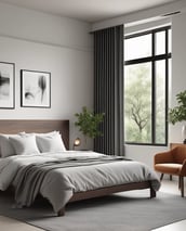 A multi-story residential building with a modern architectural design. The structure features several balconies, each with metal railing, and a flat roof with greenery visible. The facade is painted in a uniform gray tone, and a street light is positioned at the corner. Windows vary between open and covered with shutters.