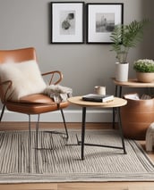 A stylish composition featuring fashion accessories on and around a white round table. There are chic red high-heeled shoes placed on the table next to sunglasses and magazines. On the floor lies a pair of rugged tan boots, and a black leather jacket is draped over the chair. This setup is placed on a textured beige rug, adding warmth to the scene.