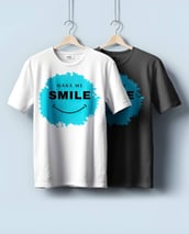 Awesome graphic-designed t-shirts with a 'Make Me Smile' slogan by Desynco, displayed on hooks.