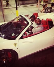 a man in a santa hat driving a white sports car