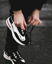 a person holding a pair of shoes in their hands