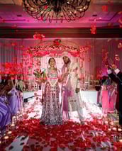 omantic mandap setup with pastel flowers and drapes by Amika Weddings and Events in Pune