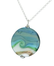 a necklace with a swirly sea design