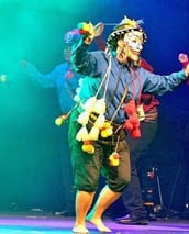 a man in a costume is holding a flag
