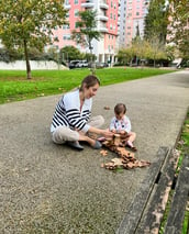 a woman sitting on a bench with a baby