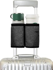 a suitcase with a cup of coffee and a cup of coffee