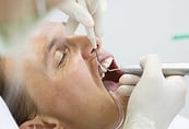 a man is getting his teeth cleaned