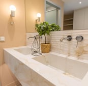 double marble bathroom, with small green plant and large mirror, 2025