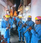 The Manohar Brass Band playing instruments in the narrow streets of Ajmer, adding musical charm to the atmosphere.
