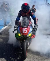 a rider doing a burnout at the end of a race