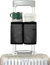 a suitcase with a cup of coffee and a cup of coffee