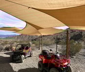 two atvs parked in a desert area