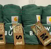 rolled up t-shirts with size labels on them