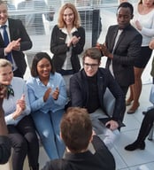 Diverse group of people smile applaud as spiritual teacher shares