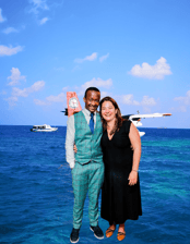 a man and woman standing in front of a plane