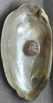 "11mm white divine designer pearl–side angle showing sacred face design and luster-for export"