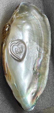 "Side-angle view of 10mm white heart-shaped cultured pearl–nucleus-based designer piece-for overseas demand"