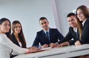 tailored training, a group of business people sitting at a table