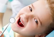 a child's smiling face at a dentist's office
