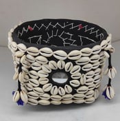 "Bamboo basket wrapped in elegant black fabric with tribal-style shell detailing and floral garland-Export-oriented"