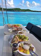 a table with a plate of food and a bottle of beer