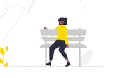 a person sitting on a bench with a bird on it