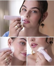 a woman is doing makeup and applying her lips